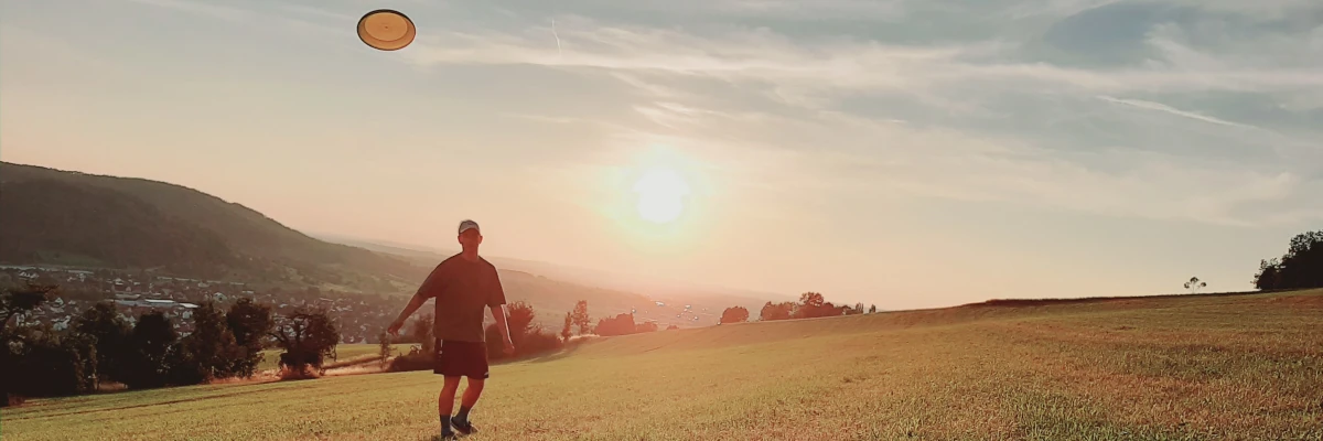 Frisbee spielen bei Sonnenuntergang